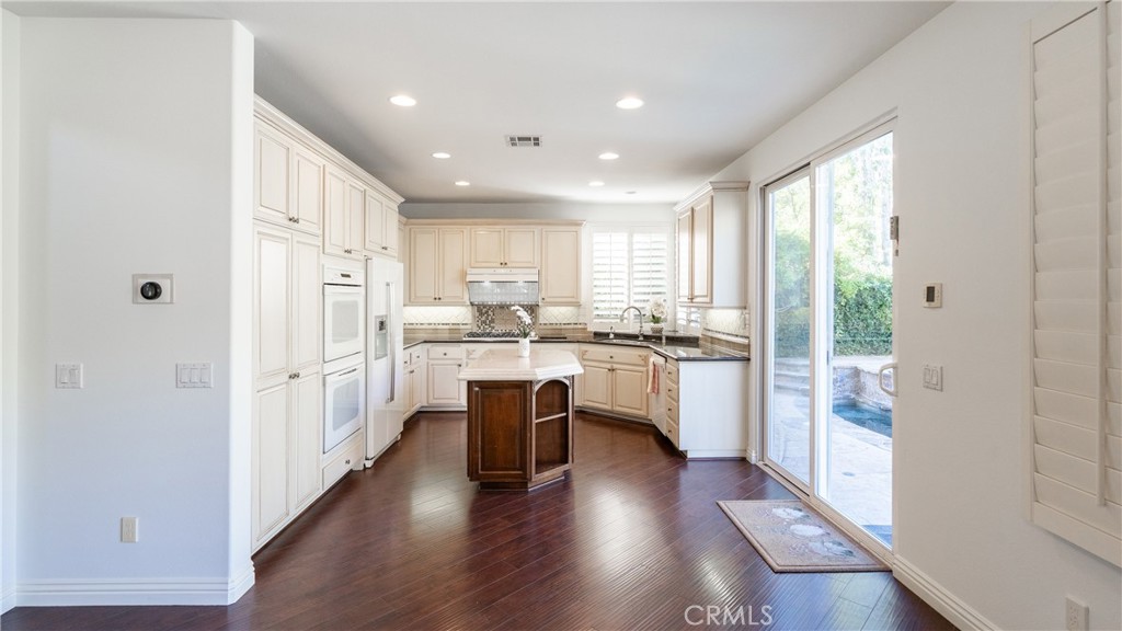 2827 Arbella Lane Thousand Oaks, CA 91362 - Photo 9 of 48 a kitchen with white cabinets and wooden floor