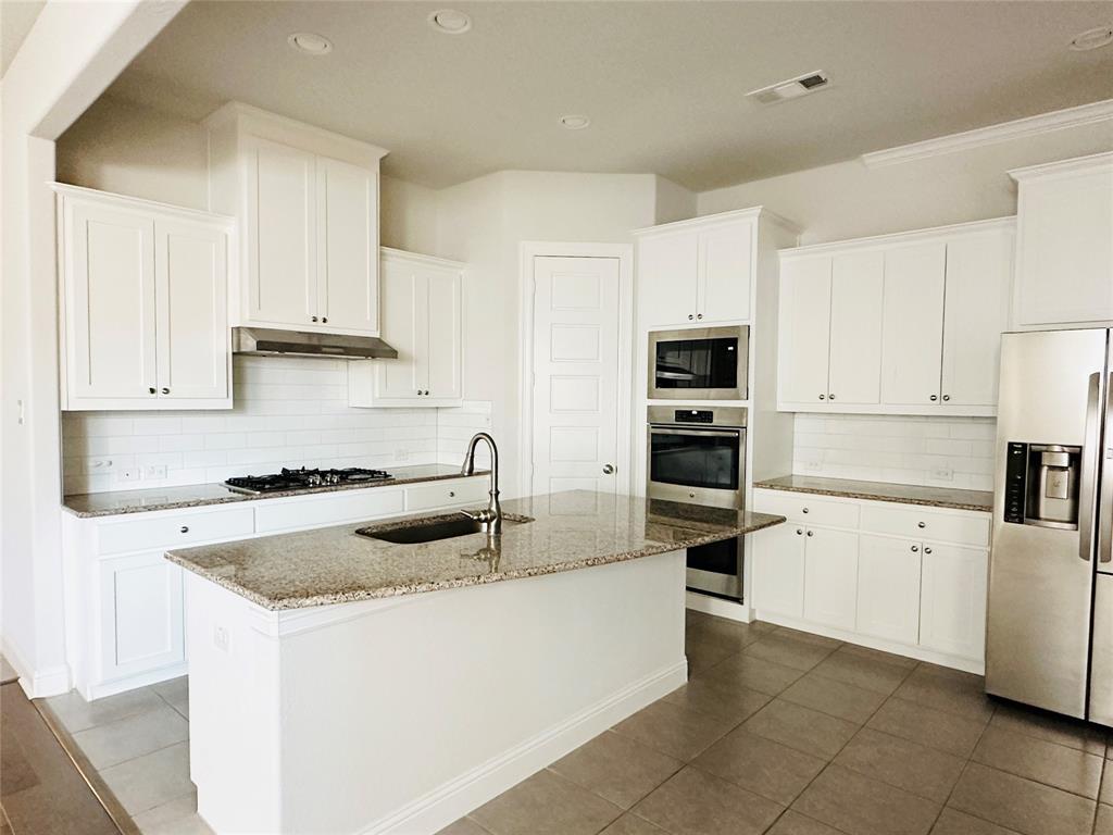 806 Davids Way Allen, TX 75013 - Photo 6 of 24 a kitchen with granite countertop a sink and white stainless steel appliances