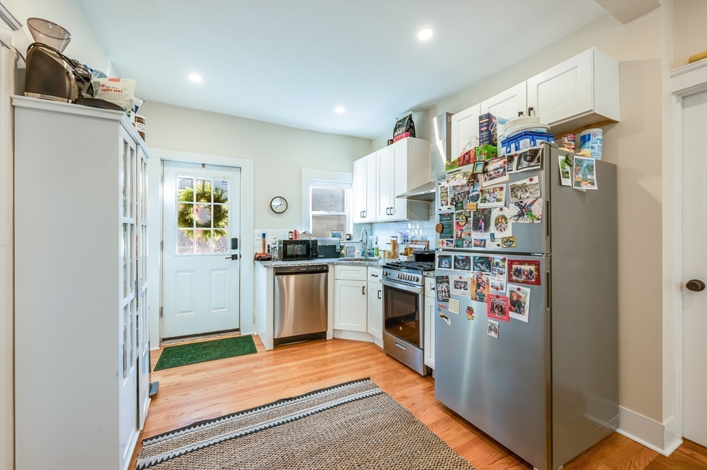 a kitchen with stainless steel appliances granite countertop a refrigerator and a sink