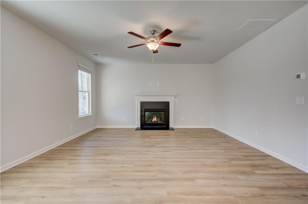 309 Exeter Court Stockbridge, GA 30281 - Photo 15 of 34 a view of an empty room with wooden floor and a window