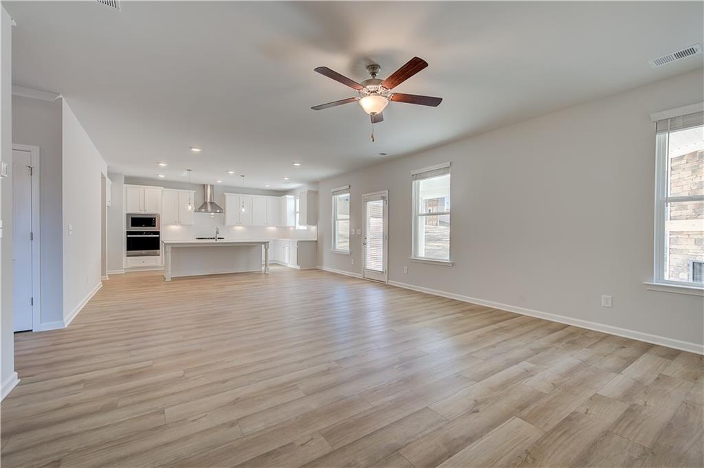 309 Exeter Court Stockbridge, GA 30281 - Photo 17 of 34 a view of an empty room with a window and wooden floor
