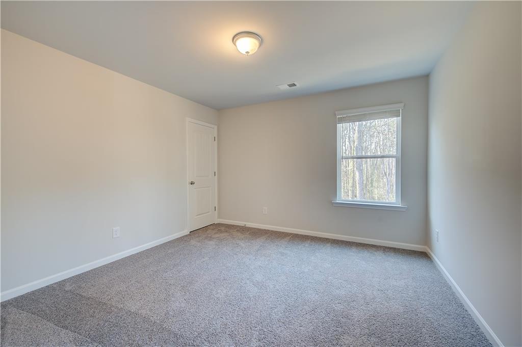 309 Exeter Court Stockbridge, GA 30281 - Photo 20 of 34 an empty room with windows
