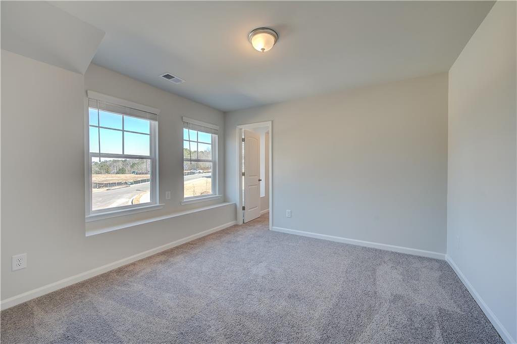 309 Exeter Court Stockbridge, GA 30281 - Photo 22 of 34 an empty room with windows and closet