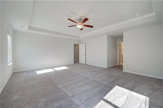 an empty room with closet and windows