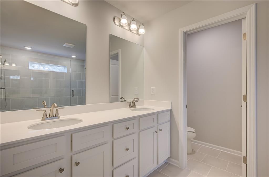 309 Exeter Court Stockbridge, GA 30281 - Photo 29 of 34 a bathroom with a sink and a mirror