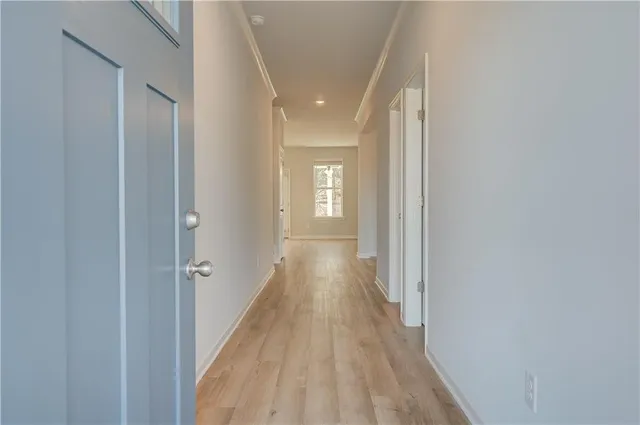 a view of a hallway with wooden floor