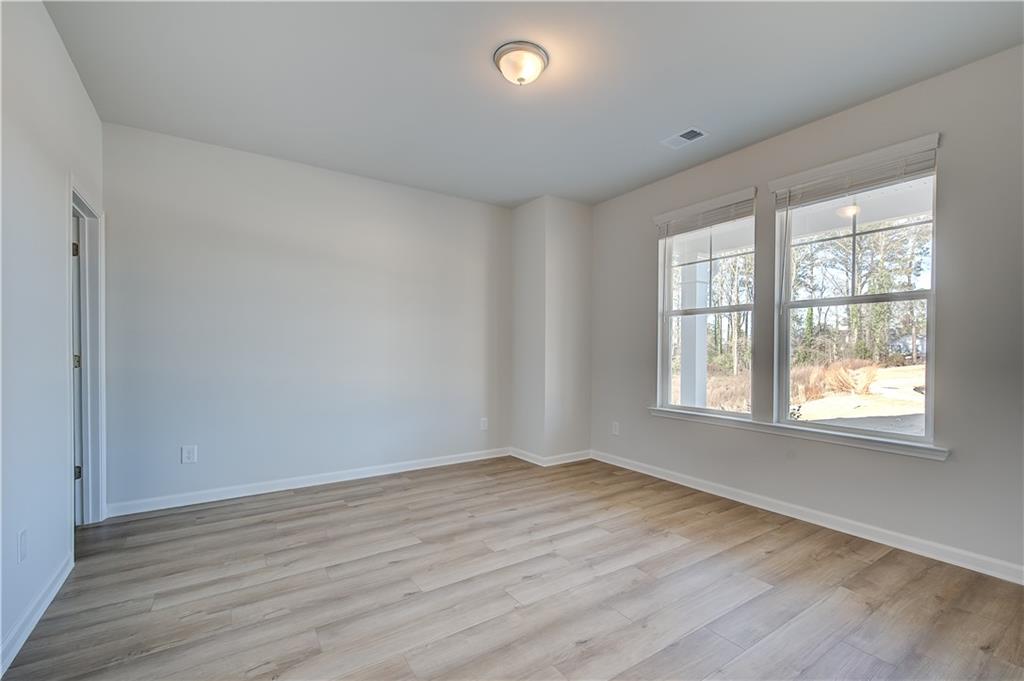 309 Exeter Court Stockbridge, GA 30281 - Photo 6 of 34 an empty room with wooden floor and windows