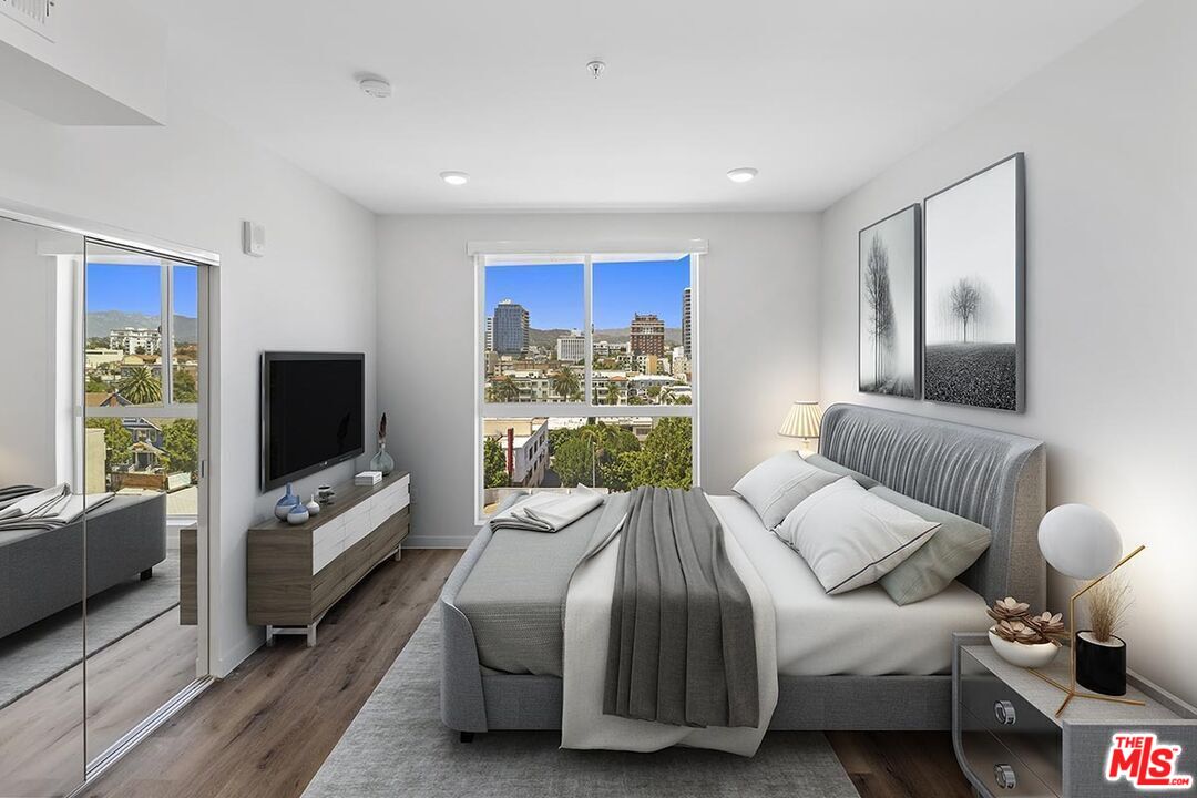 2783 Francis Avenue, Unit 307 Los Angeles, CA 90005 - Photo 4 of 9 a living room with furniture a flat screen tv and a window