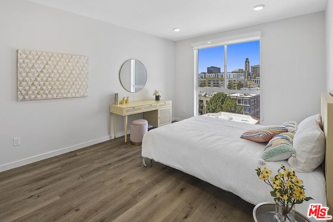 2783 Francis Avenue, Unit 307 Los Angeles, CA 90005 - Photo 5 of 9 a bedroom with a bed and wooden floor