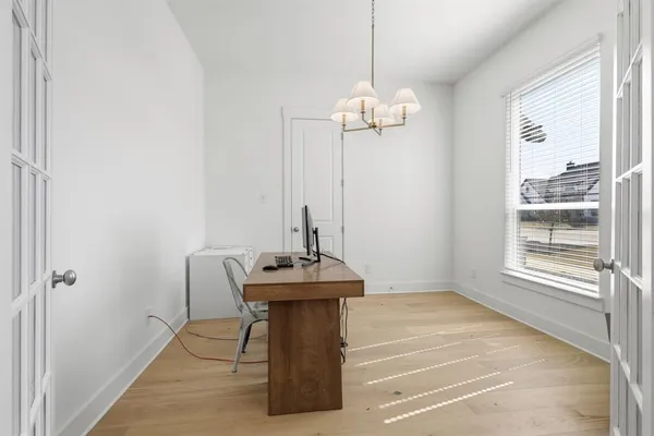 a view of a room with a chandelier a sink and windows
