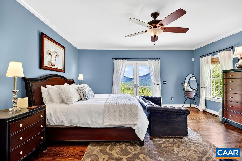 1059 Bryant Mountain Road Roseland, VA 22967 - Photo 20 of 58 a bedroom with a bed a chandelier and a dresser