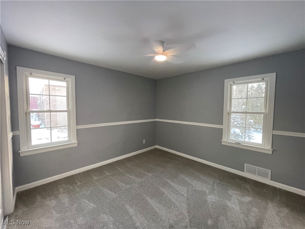 8428 Ridge Road North Royalton, OH 44133 - Photo 15 of 29 Empty room featuring light carpet, healthy amount of natural light, and ceiling fan