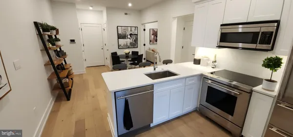 a kitchen with a sink appliances and cabinets