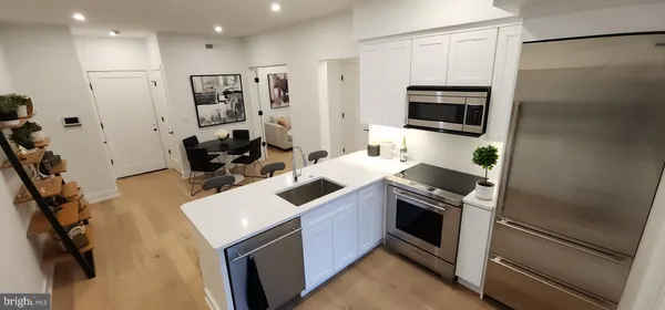a kitchen with a sink stainless steel appliances and cabinets