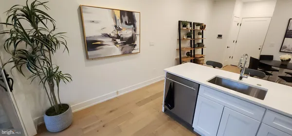 a kitchen with a sink appliances and cabinets