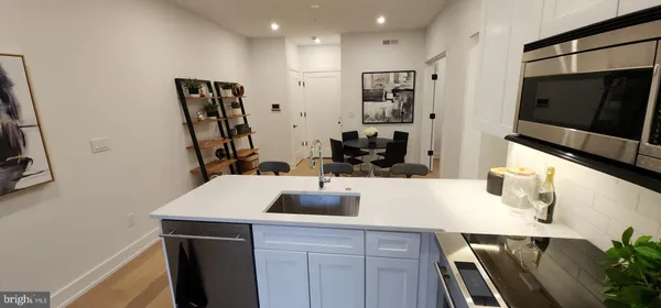 a kitchen with a sink and stainless steel appliances