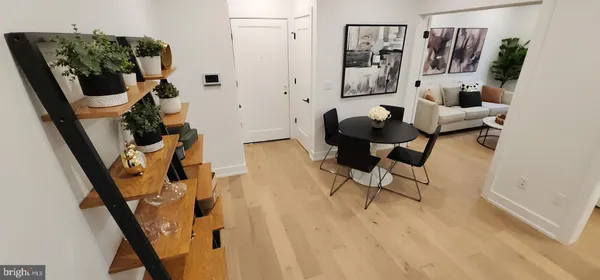 a bathroom with a sink and mirror with bathtub