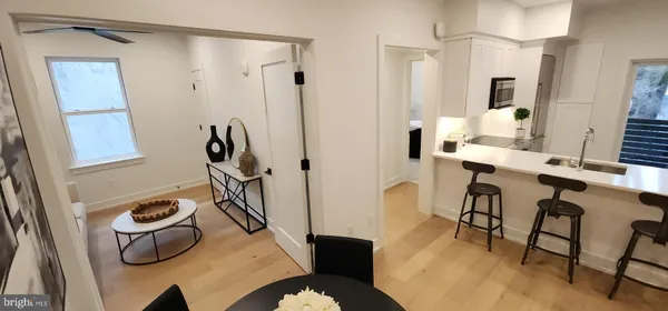 a view of a dining room with furniture and wooden floor