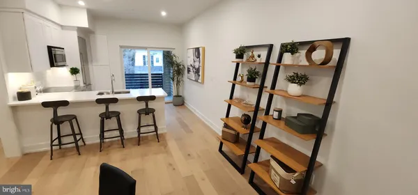 a view of a livingroom and dining room and wooden floor