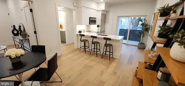 a dining room with furniture and wooden floor