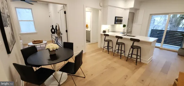 a view of a dining room with furniture and wooden floor