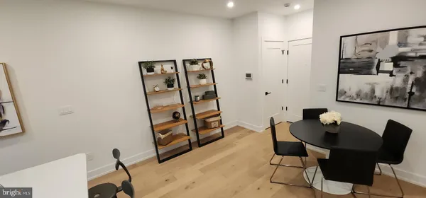 a view of a workspace with furniture and wooden floor