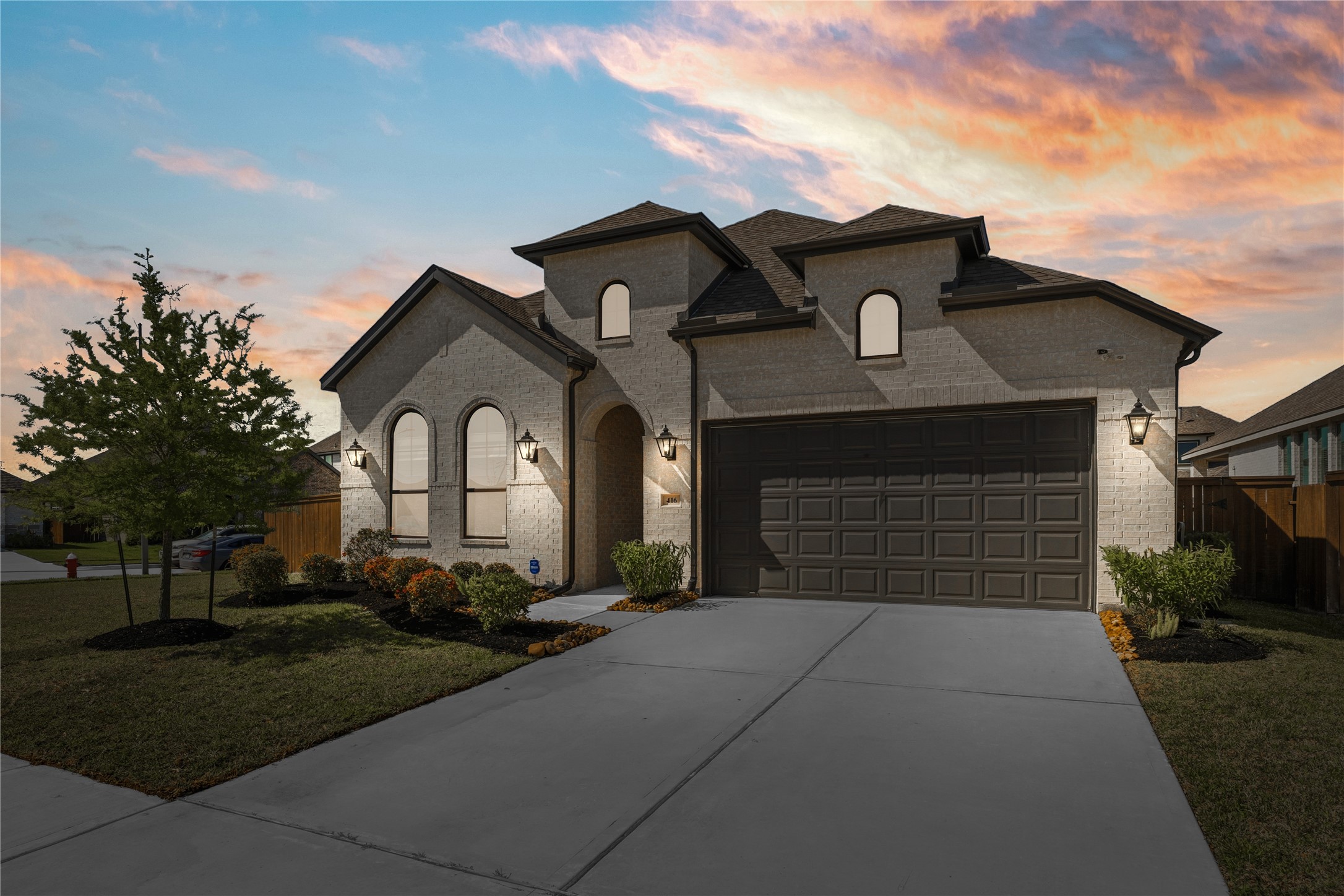 416 Bartlett Street Webster, TX 77598 - Photo 1 of 49 Sunset curb appeal — white brick, arched windows, and 2-car garage