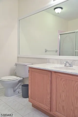 a bedroom with a bed and a refrigerator