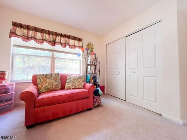 a living room with furniture and a book shelf