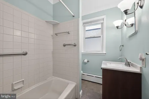 a bathroom with a sink a toilet and bathtub