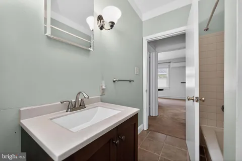 a bathroom with a sink mirror and a shower