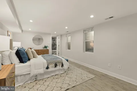 a large bedroom with a bed and a large window