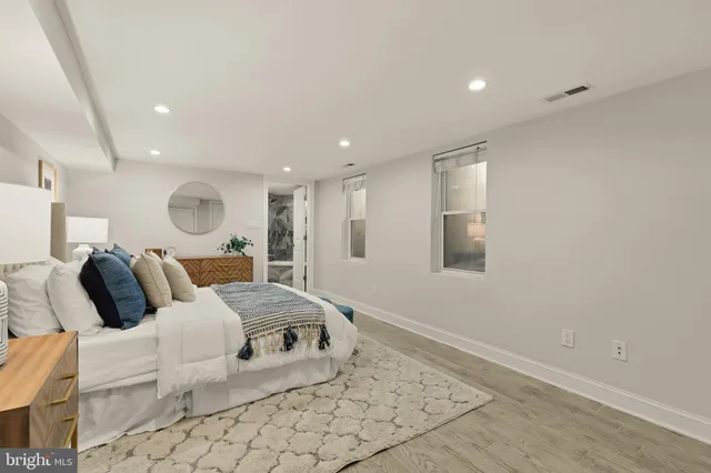 a large bedroom with a bed and a large window