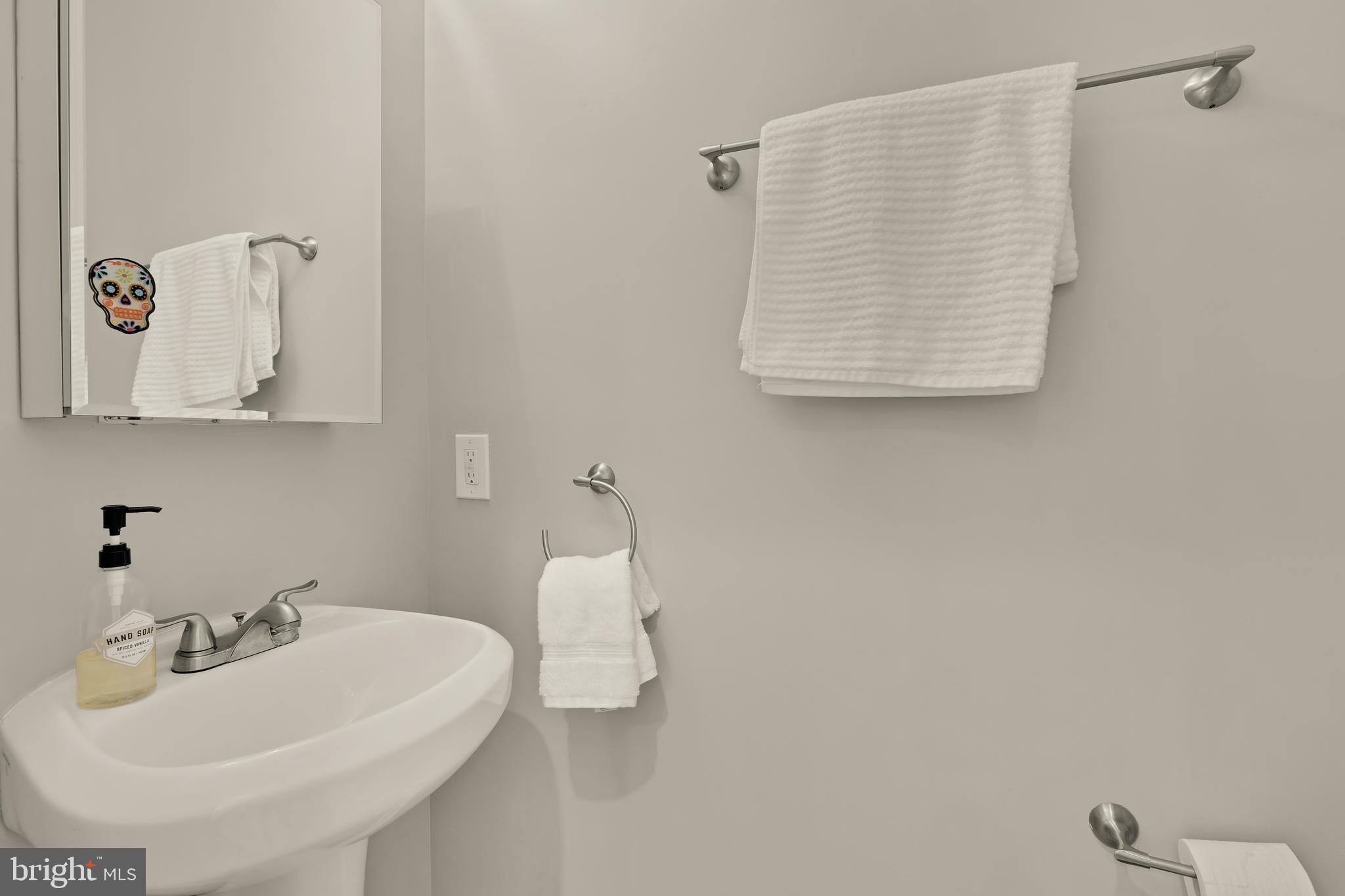 1671 Gales Street Northeast, Unit 1 Washington, DC 20002 - Photo 11 of 30 a bathroom with a sink and a mirror