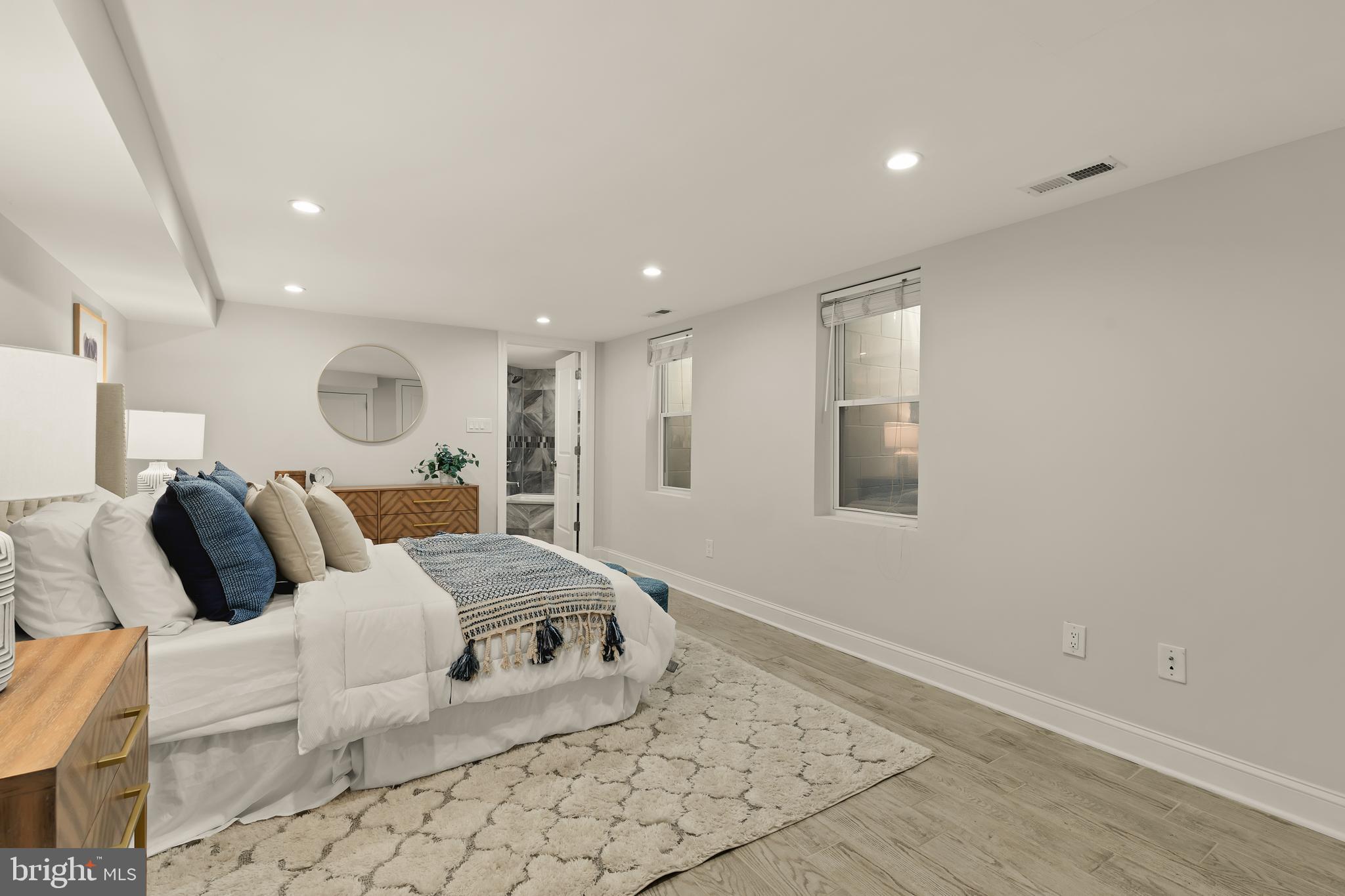 1671 Gales Street Northeast, Unit 1 Washington, DC 20002 - Photo 12 of 30 a large bedroom with a bed and a large window