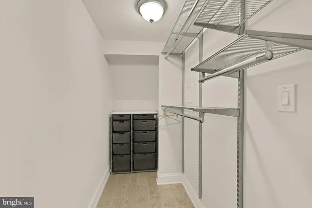 a view of walk in closet with empty racks