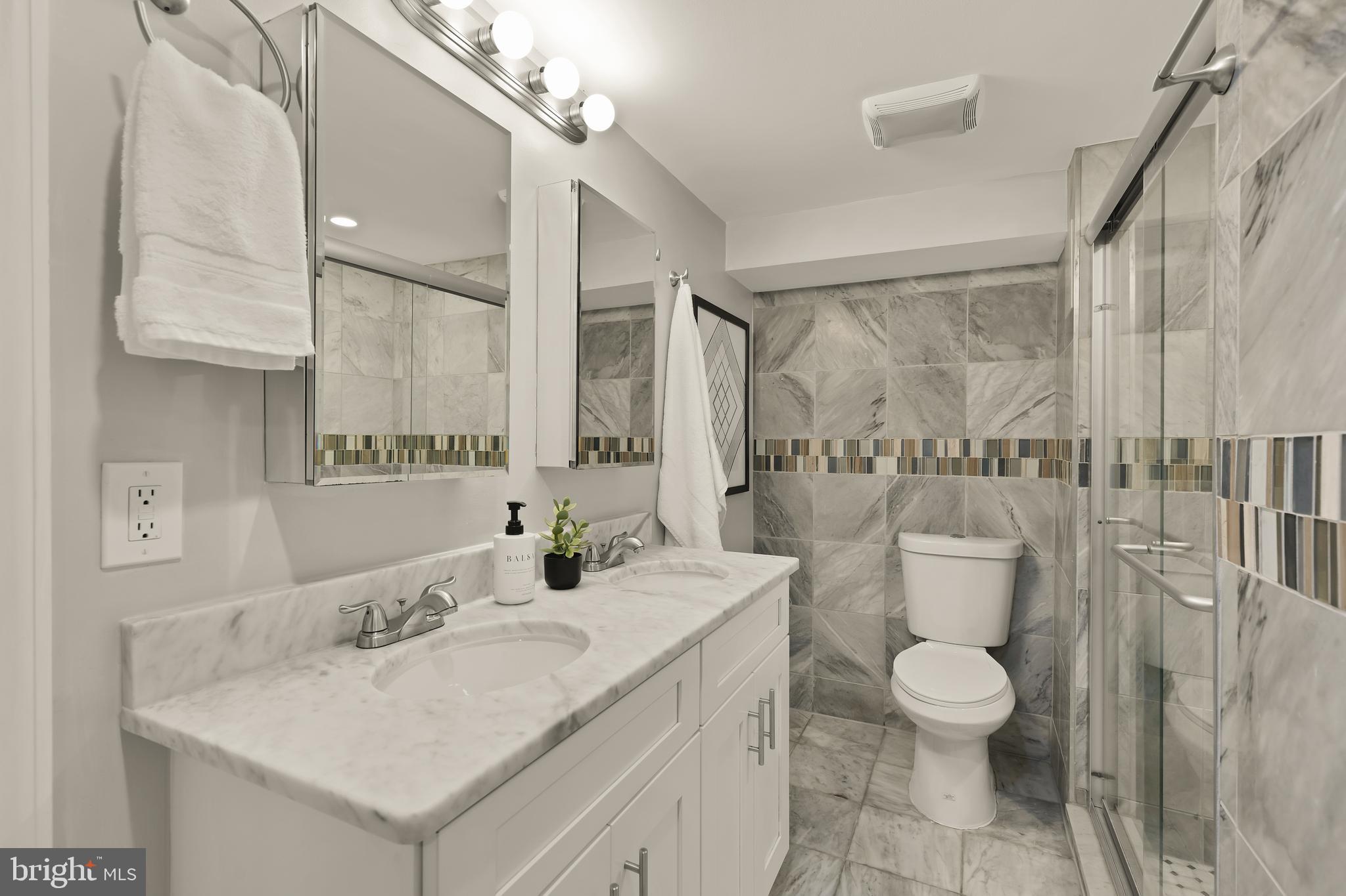 1671 Gales Street Northeast, Unit 1 Washington, DC 20002 - Photo 16 of 30 a bathroom with a toilet sink and mirror