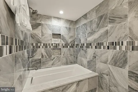 a bathroom with a bathtub and shower