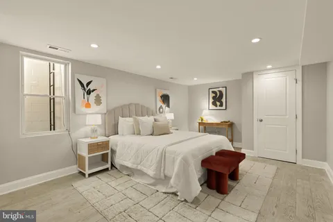 a bedroom with a large bed and a window