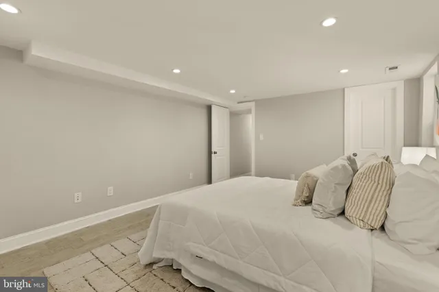 a large white bed in a white room
