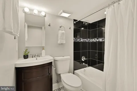 a bathroom with a sink toilet vanity and shower