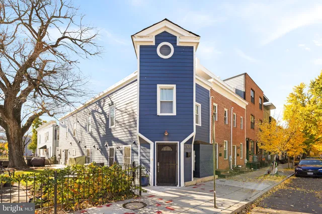 a front view of a building with trees