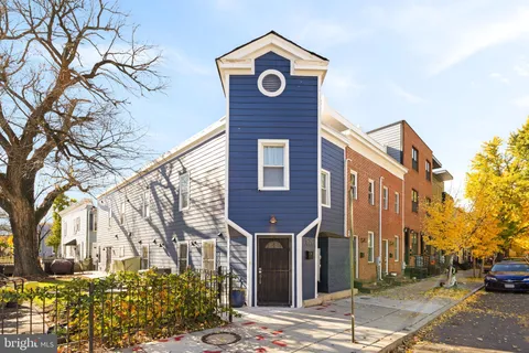 a front view of a building with trees