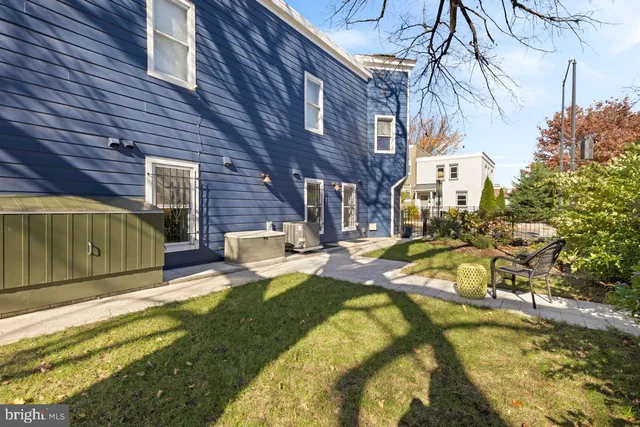 a view of a backyard with table and chairs and a fire pit