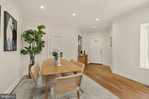 a dining room with furniture and wooden floor