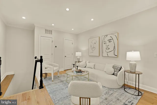 a living room with furniture a rug and a table