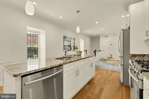 a kitchen with a sink stove and cabinets