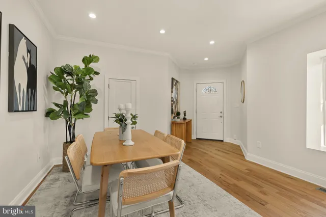 a dining room with furniture and wooden floor