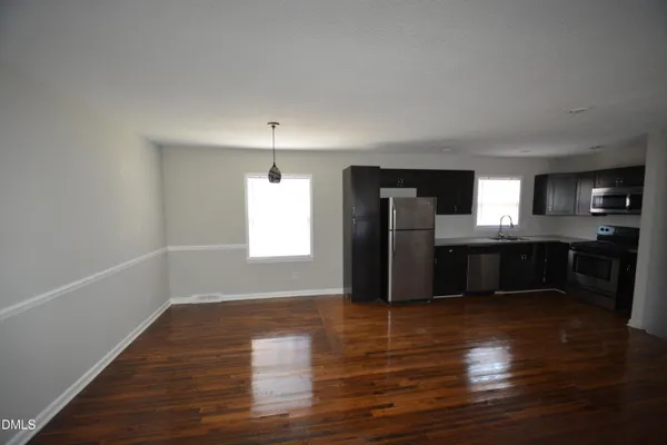 a view of a kitchen with a sink and a refrigerator