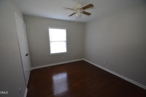 a view of a room with wooden floor and windows